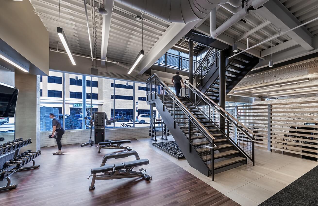 A gym with people in it and some stairs