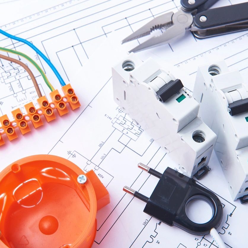 A close up of electrical components on top of a plan